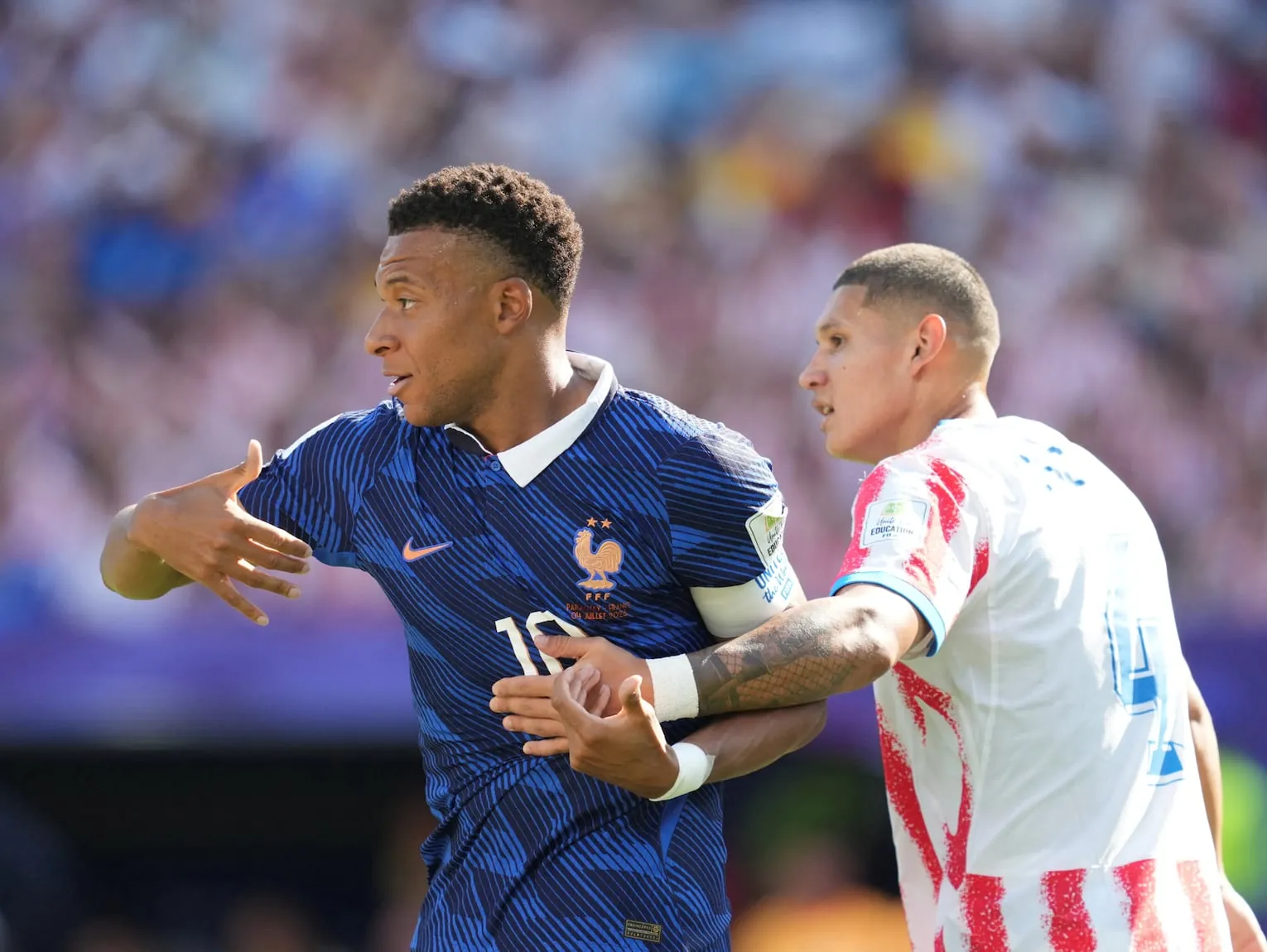 Kylian Mbappe (France) and Juan Caceres (Paraguay) during Round of 16 FIFA World Cup 2026, Paraguay and France, Philadelphia Stadium, Philadelphia, United States on July 04 2026. (Photo by Ulrik Pedersen/NurPhoto) (Photo by Ulrik Pedersen / NurPhoto via AFP)