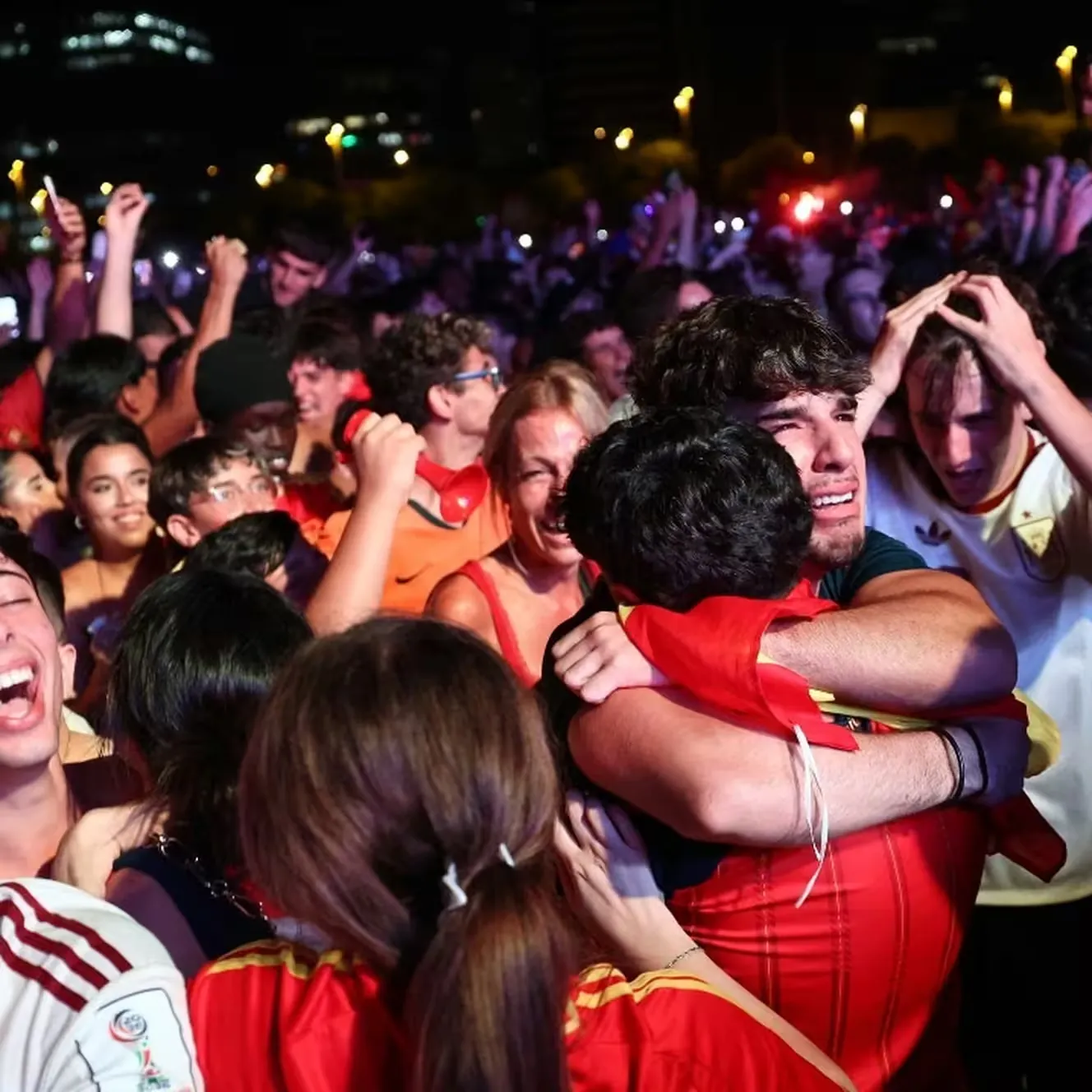 Des supporters espagnols c&eacute;l&egrave;brent le but de l'Espagne lors de la finale de la Coupe du monde 2026 entre l'Espagne et l'Argentine, diffus&eacute;e sur un &eacute;cran g&eacute;ant dans la fan zone du quartier du Forum &agrave; Barcelone, le 19 juillet 2026. (JOSEP LAGO / AFP)